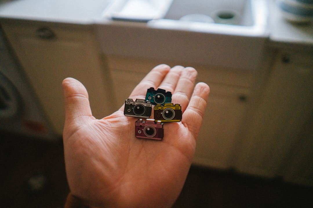 hand holding miniature mechanical key clicker keychain pressing single colorful keycap