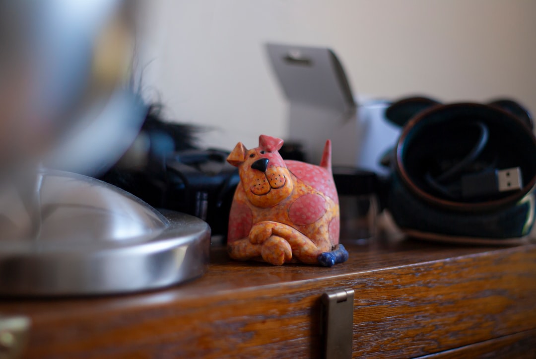 assortment of custom artisan resin keycaps shaped like animals and food on office desk