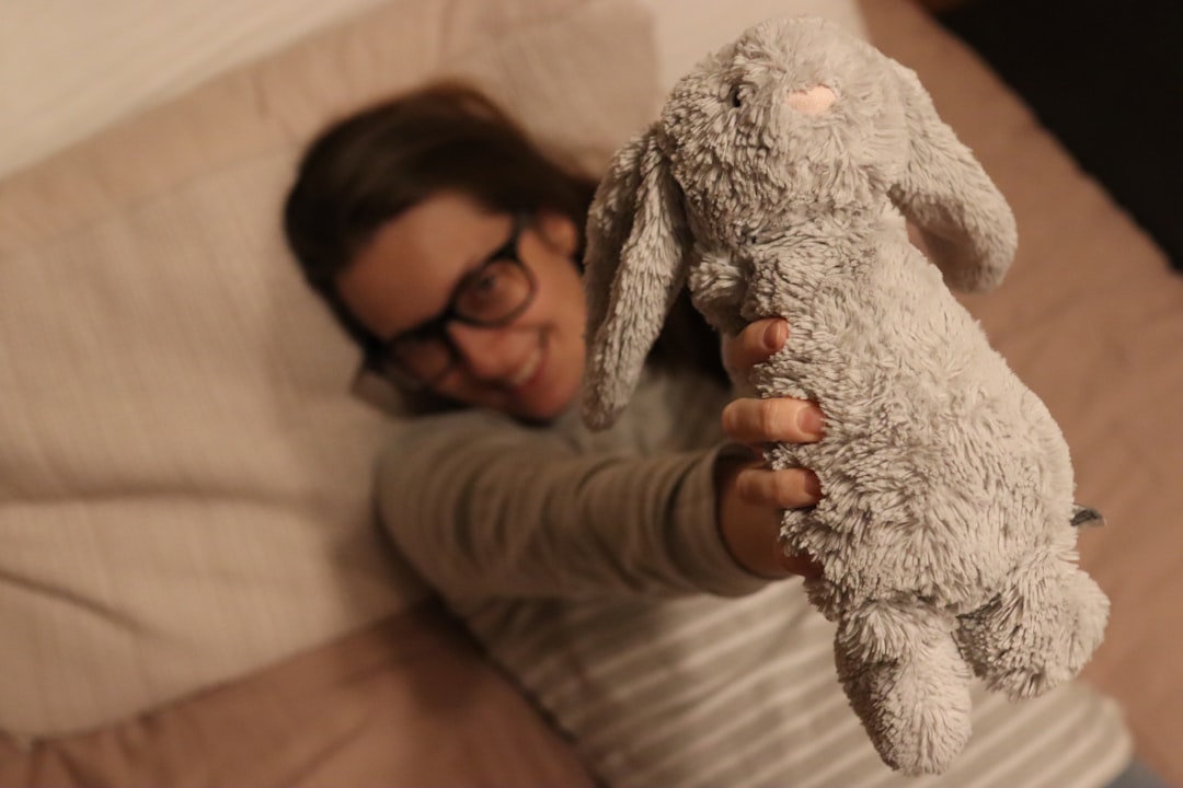 person holding weighted stuffed animal